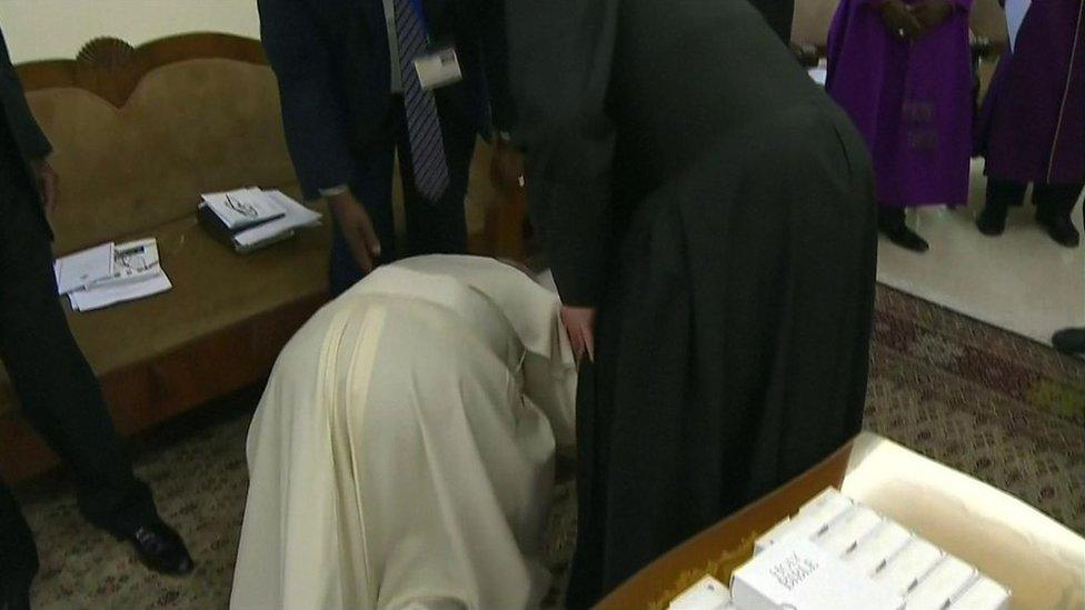 Pope Francis kisses the feet of one of South Sudan's leaders