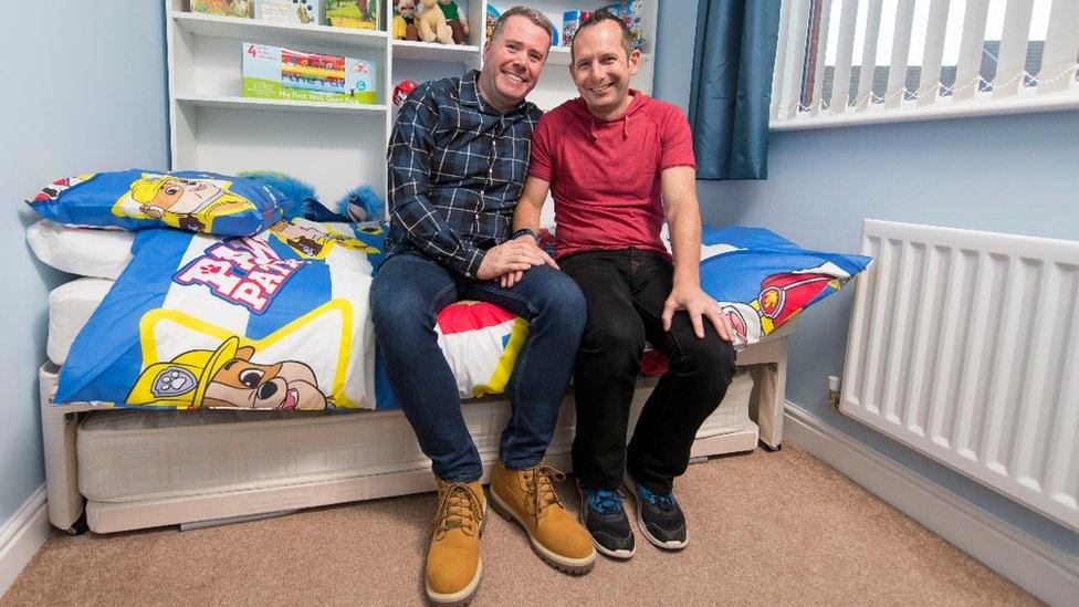 Mike and Tony in a bedroom decorated for a young boy