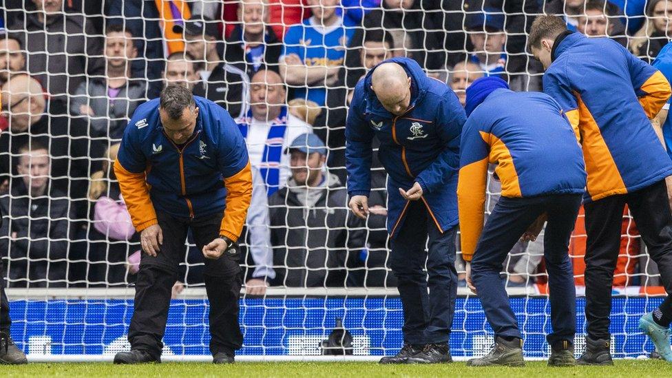 Rangers groundstaff search for more glass after shards from a broken bottle were found in the Celtic penalty area