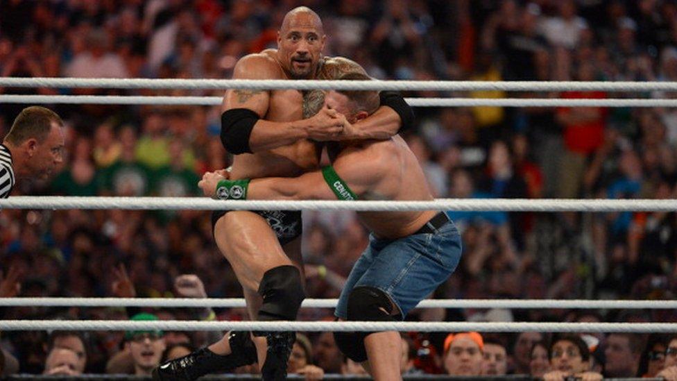 Dwayne ''The Rock'' Johnson and John Cena in action during WrestleMania XXVIII in 2012