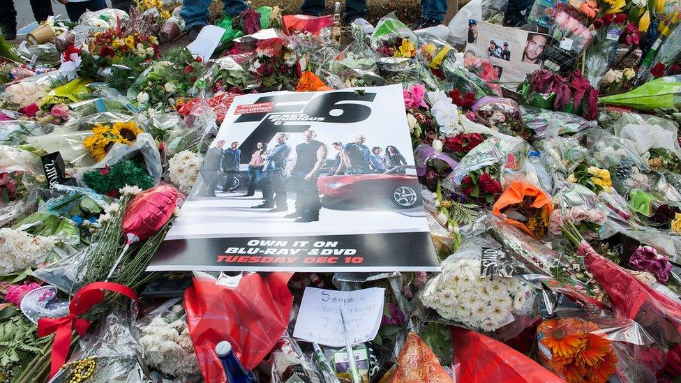 Fans brings letters, poem, photos, flowers, candles, toys... and even a Christmas tree at the Paul Walker Fan Memorial on 8 December 2013 in Valencia, California