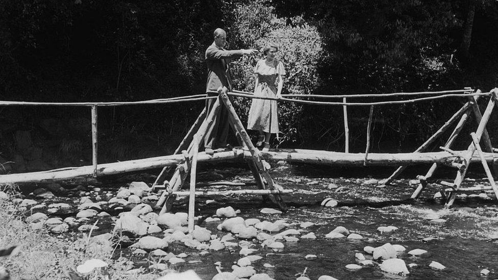 Princess Elizabeth and the Duke of Edinburgh admiring the view from a bridge in the grounds of Sagana Lodge, their wedding present from the people of Kenya. 5 February 1952: