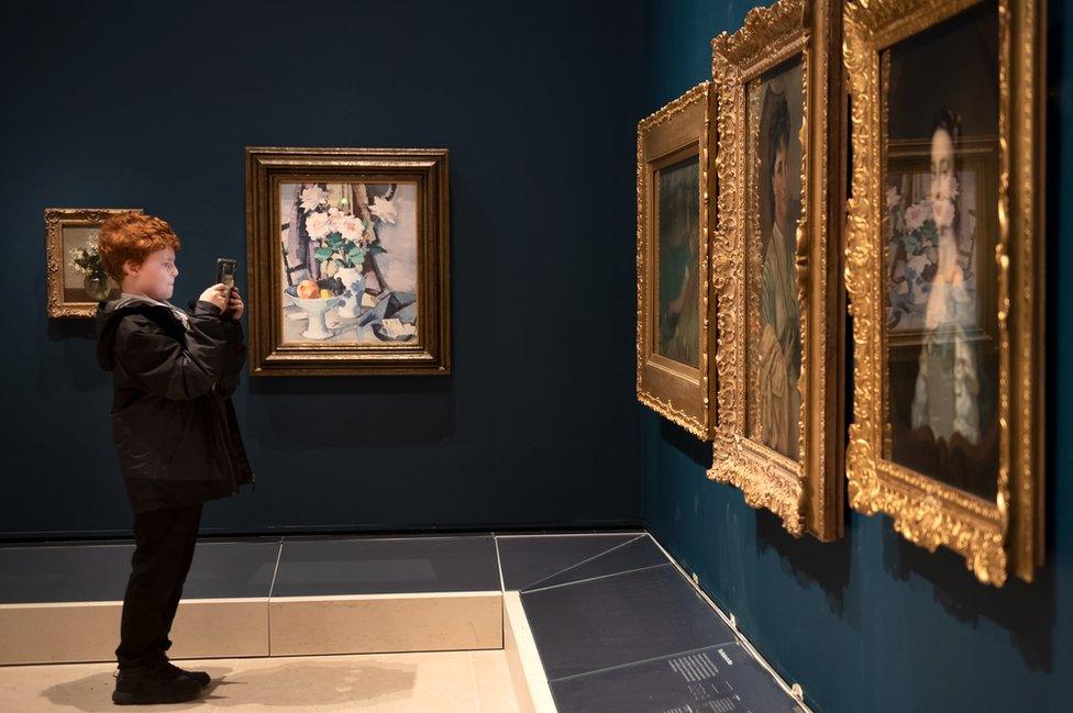 A young visitor takes in the paintings in the Central Gallery