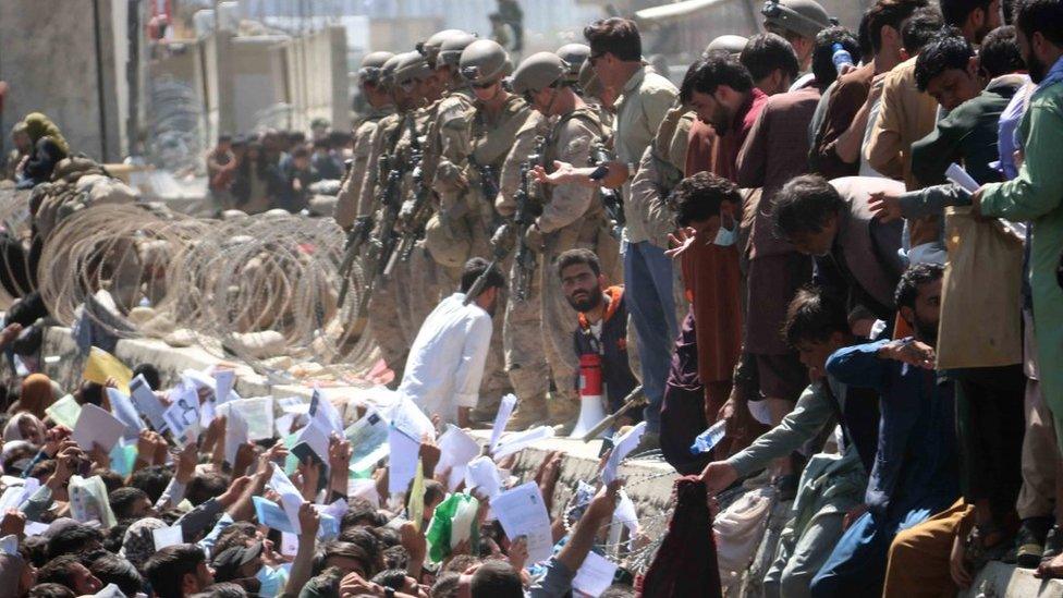 Afghans struggle to show their credentials to flee the country outside Kabul International Airport, Afghanistan, 26 August 2021