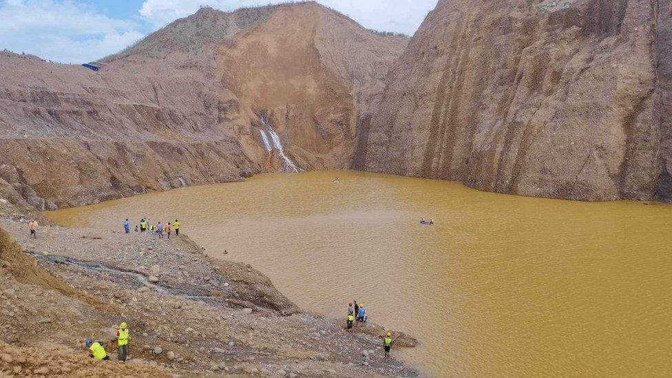 Rescue workers trying to locate the missing miners swept into the lake after a landslide on Sunday