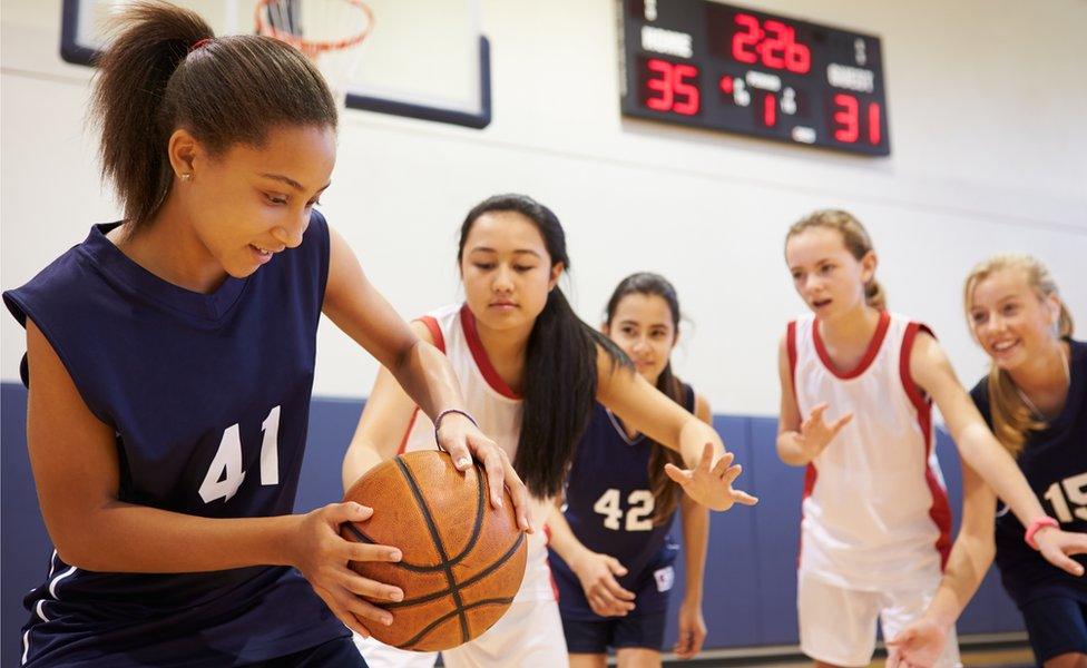 Teenagers playing basketball