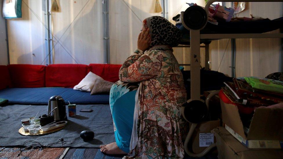 Syrian refugee Walaa, 26, sits inside her family's tent at the Souda municipality-run camp on the island of Chios, Greece