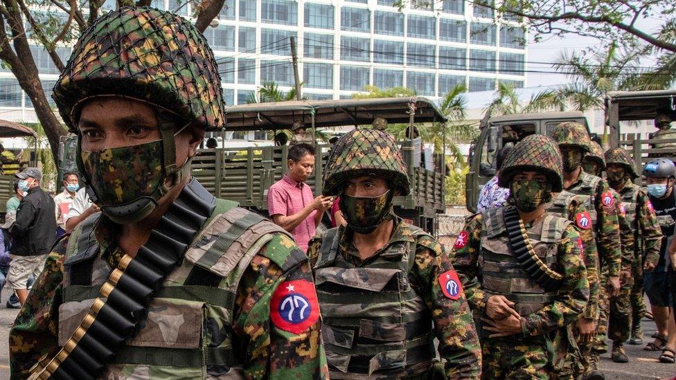 Soldiers are seen patrolling the streets in Thingangyun