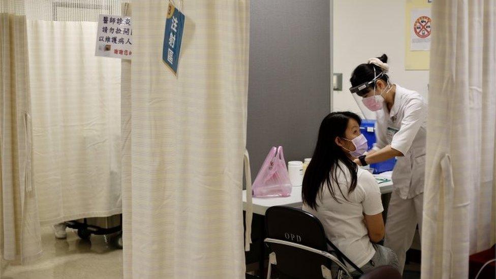 A medical frontline worker receives the AstraZeneca (Vaxzevria) COVID-19 vaccine at a hospital in New Taipei, Taiwan, 20 May 2021.