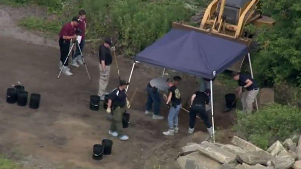 investigators digging in dirt