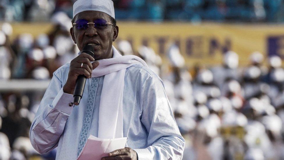 Chadian President Idriss Deby Itno holds his notes as he addresses supporters at his election campaign rally in N'Djamena on April 9, 2021