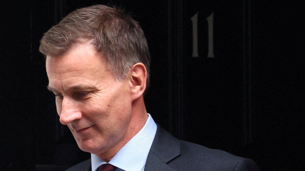 British Chancellor of the Exchequer Jeremy Hunt leaves Downing Street in London.