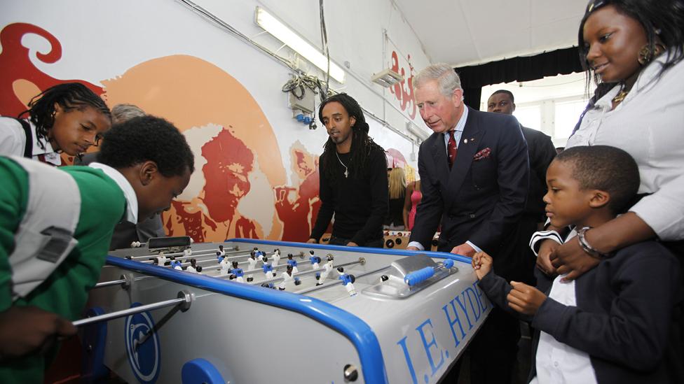 Prince Charles plays table football with children at Kids Company, 2009