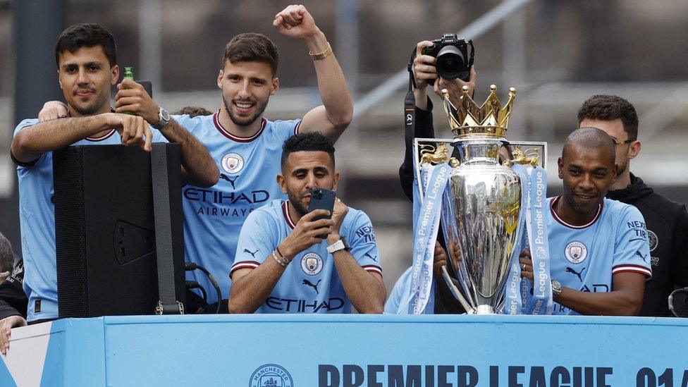 Fernandinho, Riyad Mahrez, Rodri and Ruben Dias celebrate with the Premier League trophy