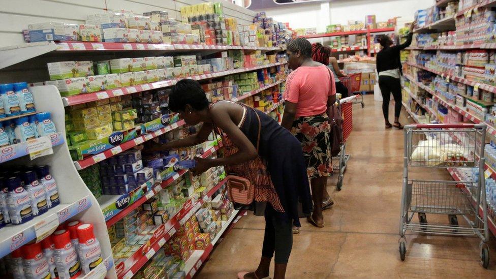 Shoppers buying supplies at supermarket