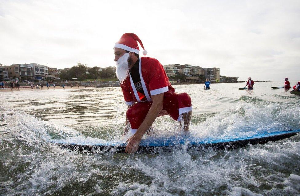 A pack of 320 surfing Santas embrace the Christmas spirit in Australia, breaking the Guinness World Record for the largest surf lesson.