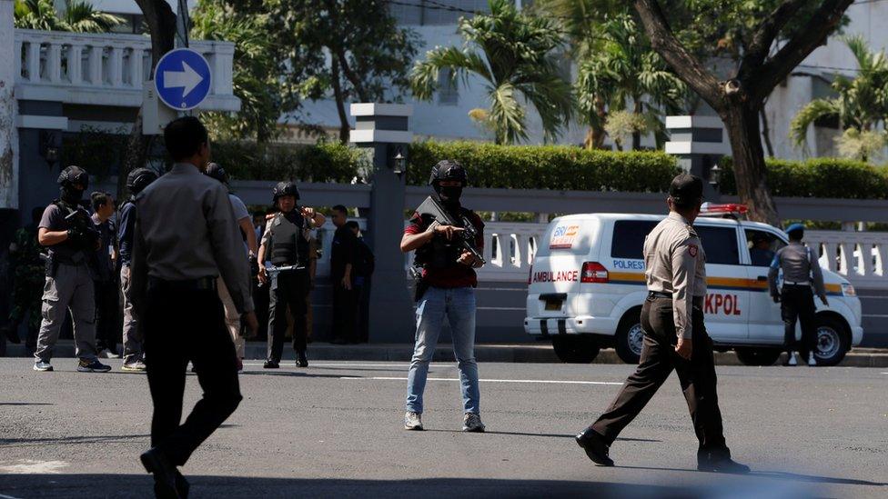 Police outside the police office following the blast