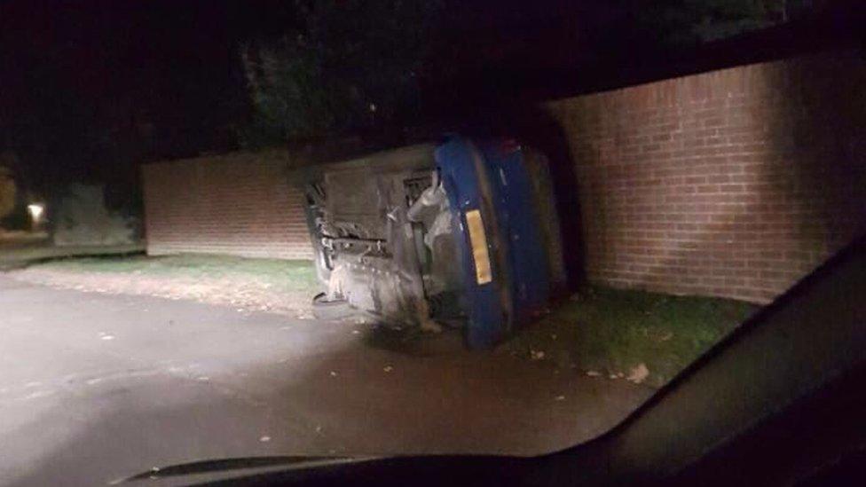 A fork-lift truck tipped over a car in Baskerville Road