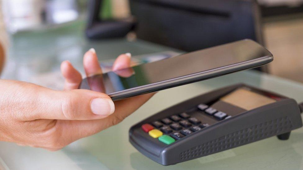 Woman paying with NFC technology