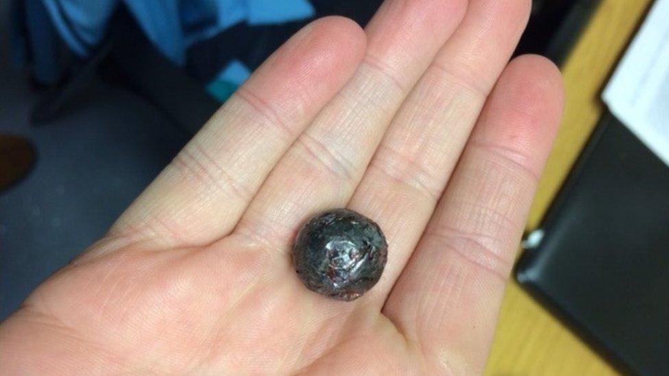 A ball bearing in someone's hand