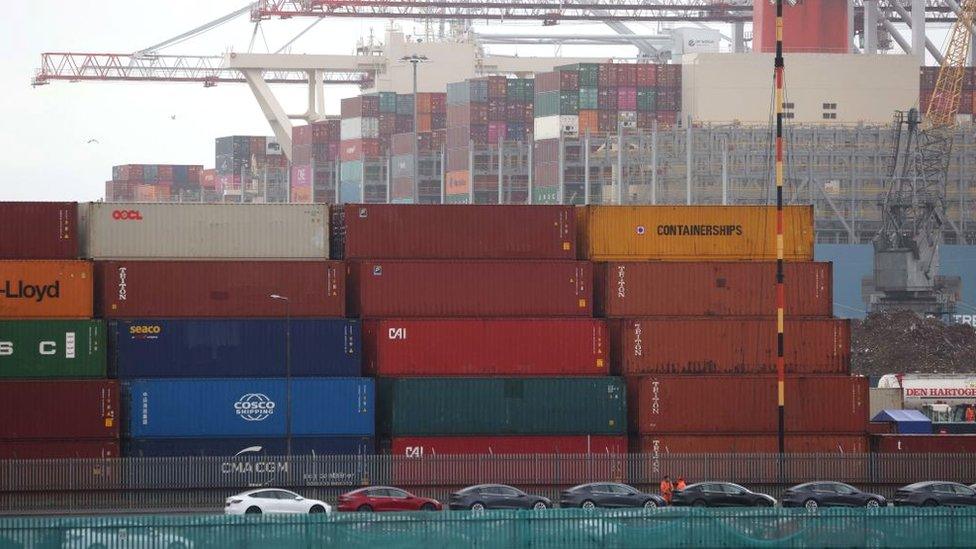 Tesla vehicles and shipping containers queued up at the container terminal of Southampton Docks