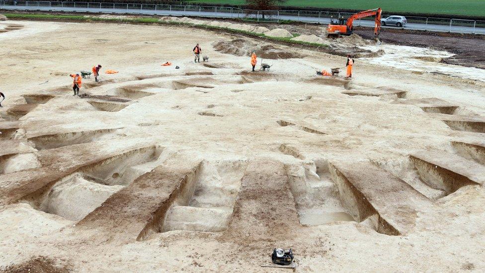 Archaeologist around the round barrows on the sit in Harnham