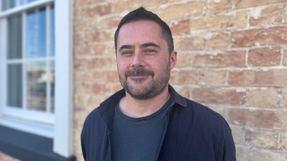 Step Together's Mark Brown standing in front of a brick wall