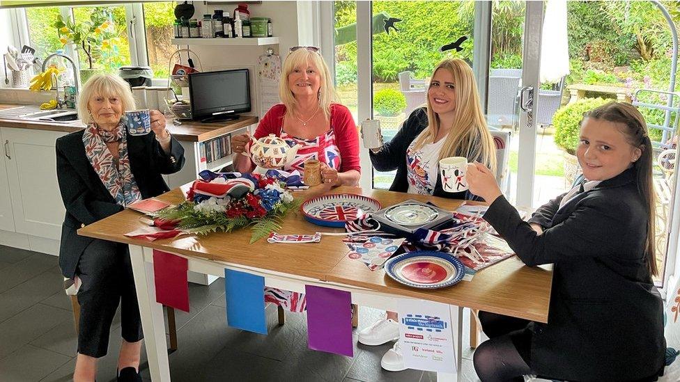 four women sitting around a kitchen table