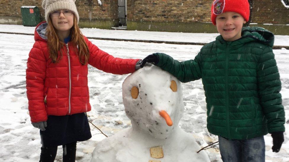 Twins with a snowman