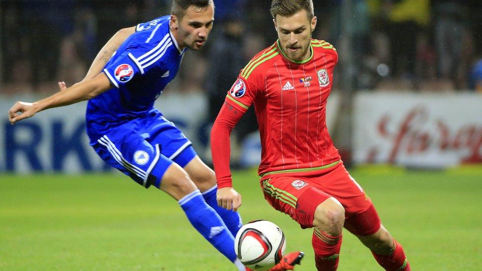 Aaron Ramsey (r) in action against Anel Hadzic of Bosnia