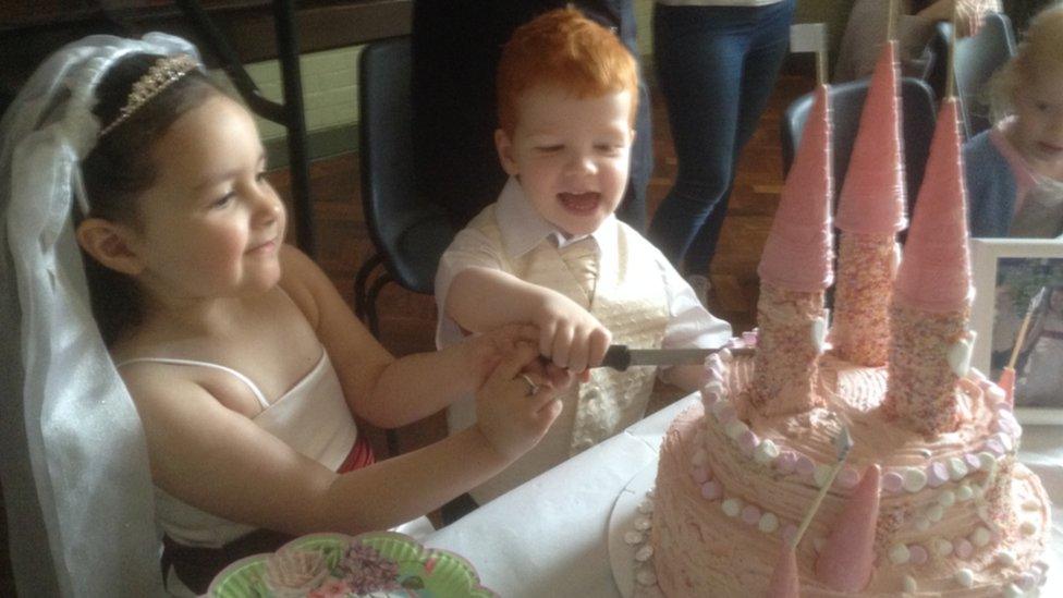 Children cut cake at fake Royal wedding.