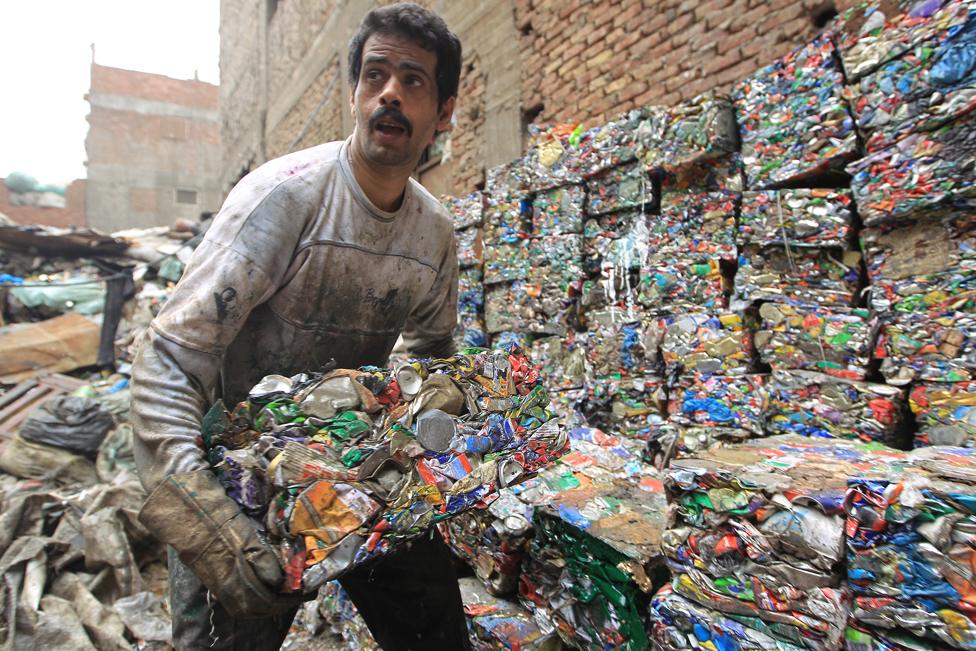 An Egyptian garbage collector works in the impoverished Al-Zabbalin area in Al-Mukatam neighbourhood in the Egyptian capital Cairo on April 20, 2010