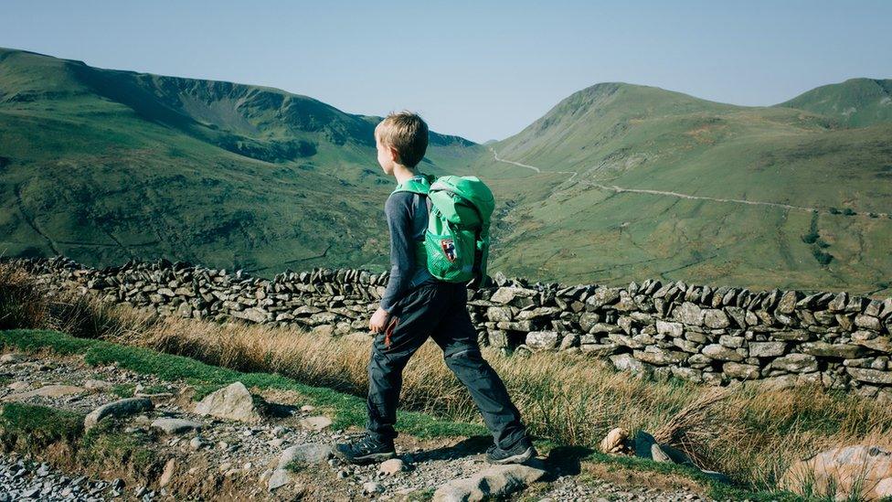 Boy hiking the mountains in Snowdonia National Park.