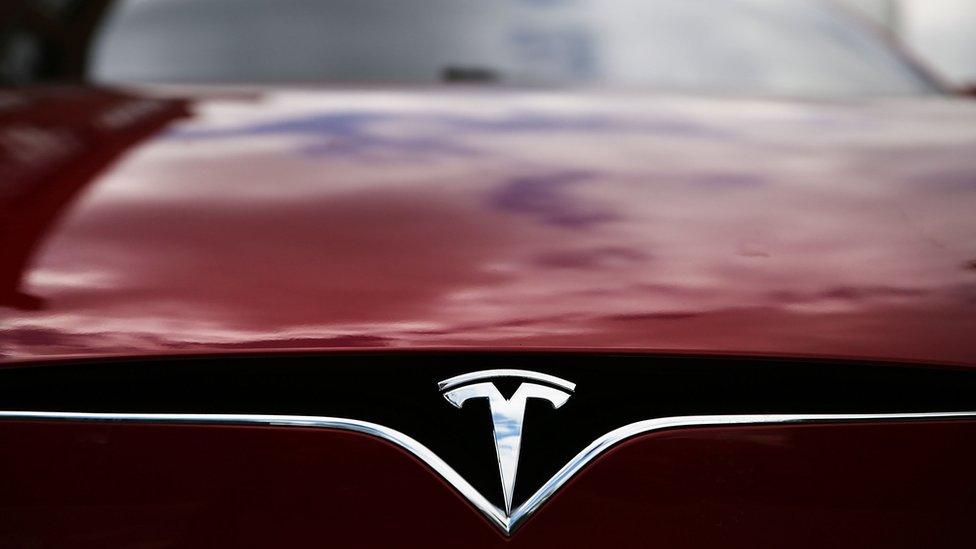 A Tesla model S sits parked outside of a new Tesla showroom and service center in Red Hook, Brooklyn on July 5, 2016 in New York City.