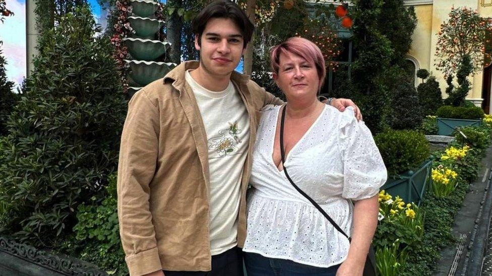 Picture of Jack and Nikki Clarke. They are stood together, smiling at the camera. Jack has his arm around Nikki.