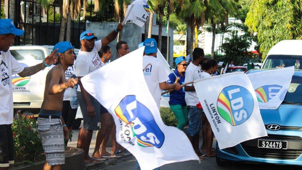 Supporters of the presidential candidate Wavel Ramkalawan dance and chant slogans as they celebrate his victory, in the streets of Victoria, on October 25, 2020.