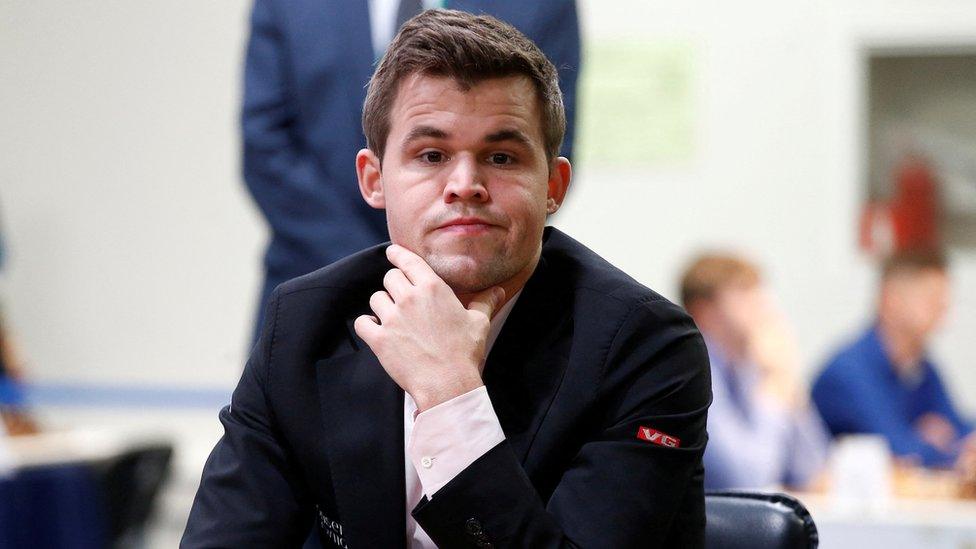 Chess player Magnus Carlsen pictured at a chess board during a tournament