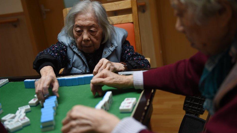 Elderly people playing dominoes in a Chinese nursing home