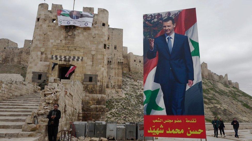 The citadel, decorated with a flag of President Assad and with a large poster of the Syrian ruler outside