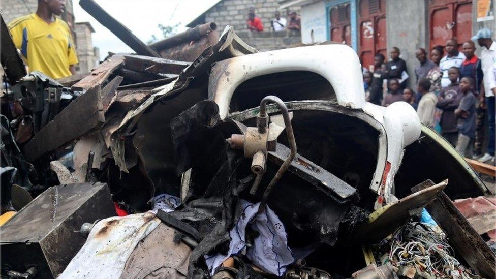 Civilians gather at the site where a Dornier 228-200 plane operated by local company Busy Bee crashed into a densely populated neighborhood in Goma, eastern Democratic Republic of Congo November 24, 2019