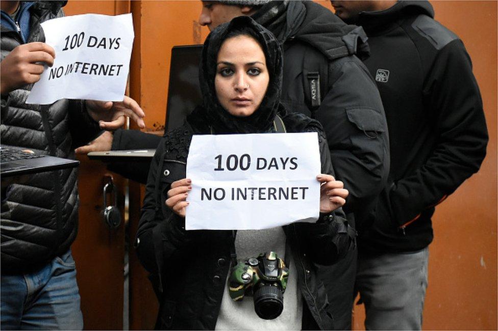 A Kashmiri journalist hold a placard during protest against the continous internet blockade for 100th day out Kashmir press club , Srinagar, Indian Administered Kashmir on 12 November 2019.