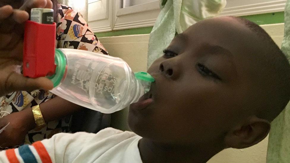 A child with asthma in Senegal using a respirator