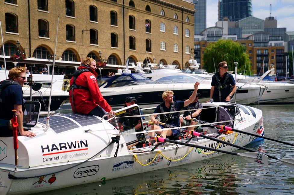 Crew from team Albatross, including Olympic rower Andrew Triggs Hodge (centre), leave the start point of the GB Row Challenge in St Katherine Dock in central London.