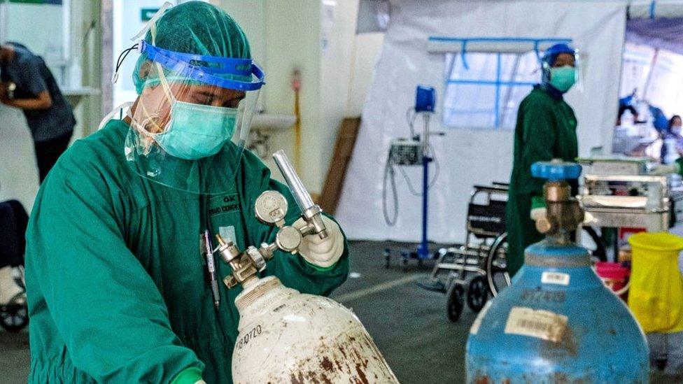 Medical staff with oxygen container