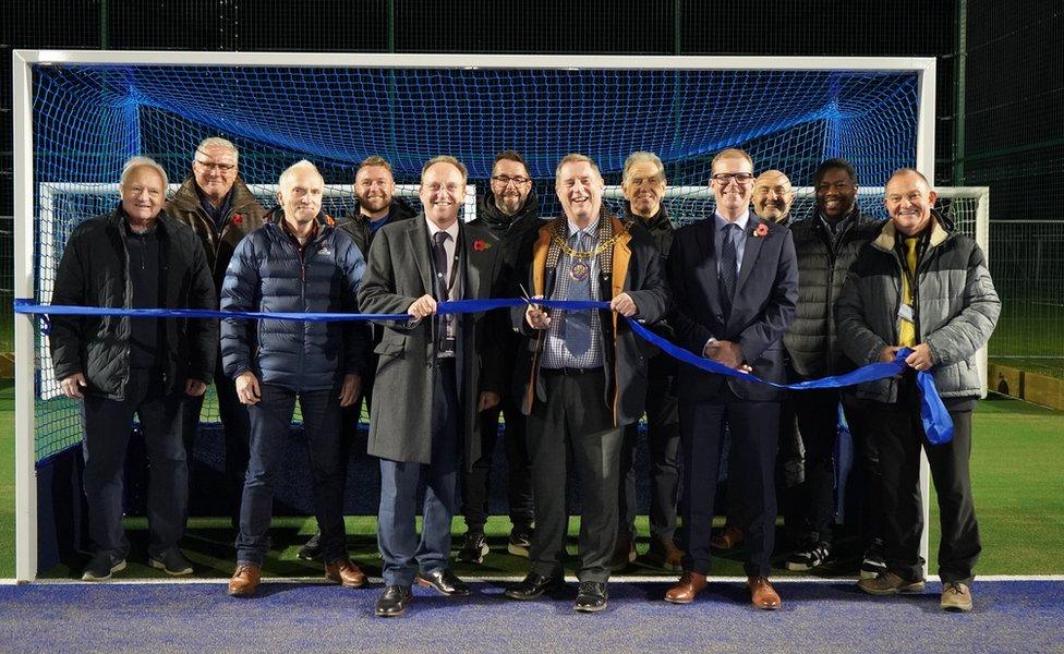 Robert Raphael, chairman of Wychavon District Council, helps Pershore High School and members of Pershore Hockey Club to open the new hockey pitch