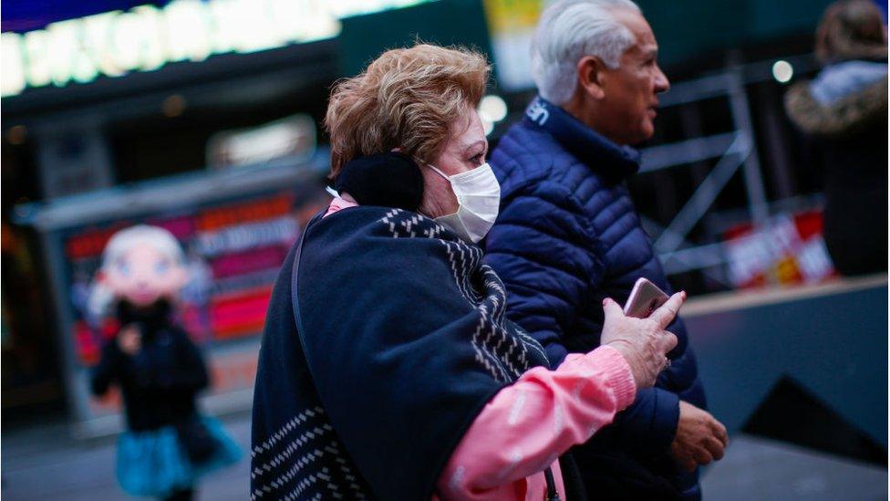 Woman wearing mask in Times Square, New York