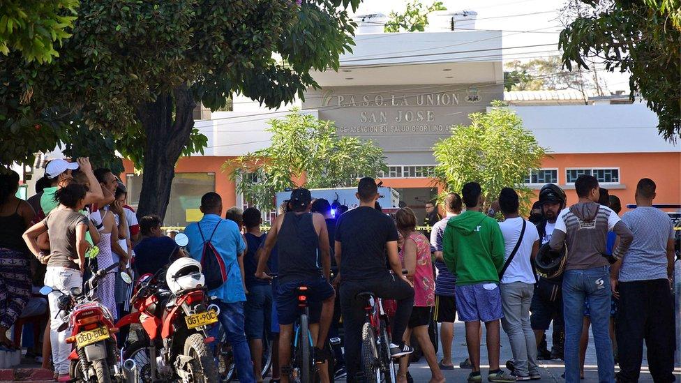 People look on outside a hospital, after an attack on the Station of the District San Jose, in Barranquilla, Colombia January 27. 2018.