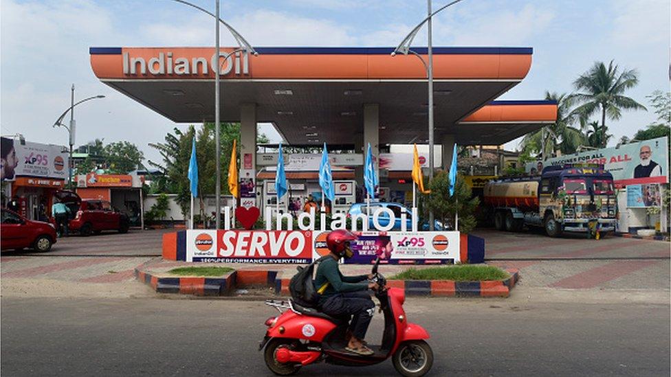 A rider in his scooter passes by Indian Oil petroleum pump in Kolkata, India, 28 October, 2021