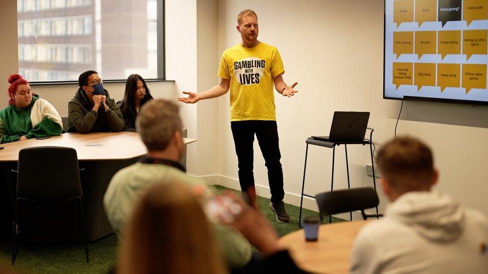 James Grimes, head of education at Gambling With Lives, with students at the UA92 in Manchester