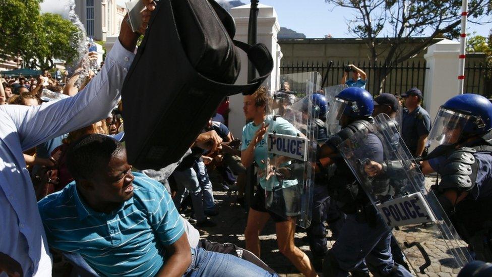 South African students clash with police during violent protests in the parliament precinct, Cape Town, South Africa, 21 October 2015